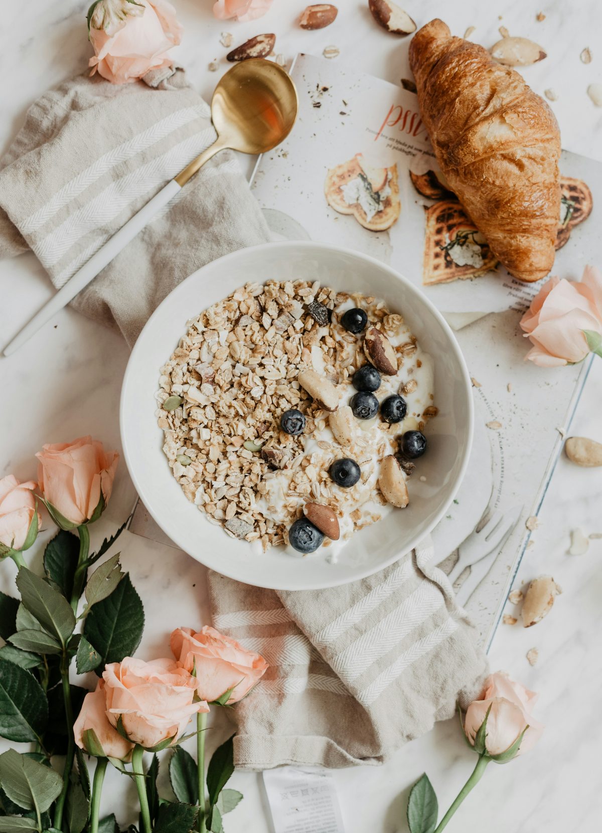 A breakfast bowl of oats and blueberries with seeds, on a linen cloth.