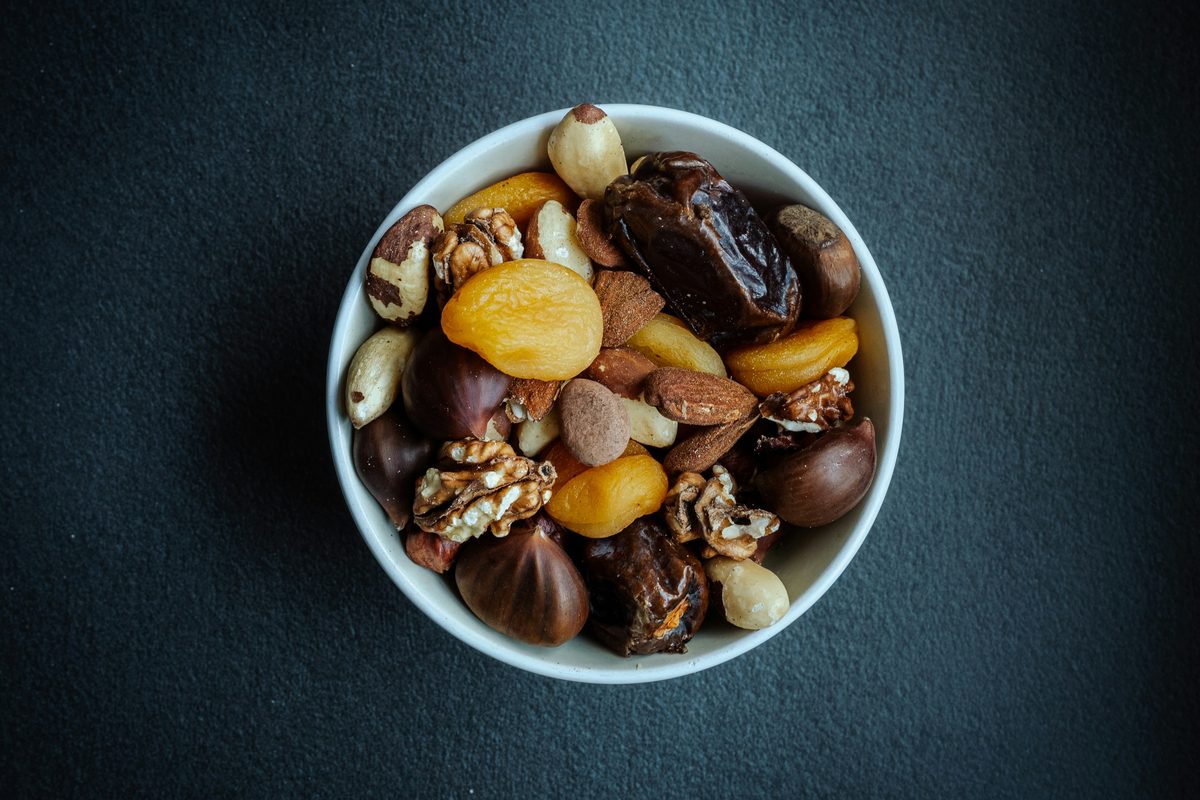 A small bowl of mixed nuts and dried fruit, an easy one-handed snack.